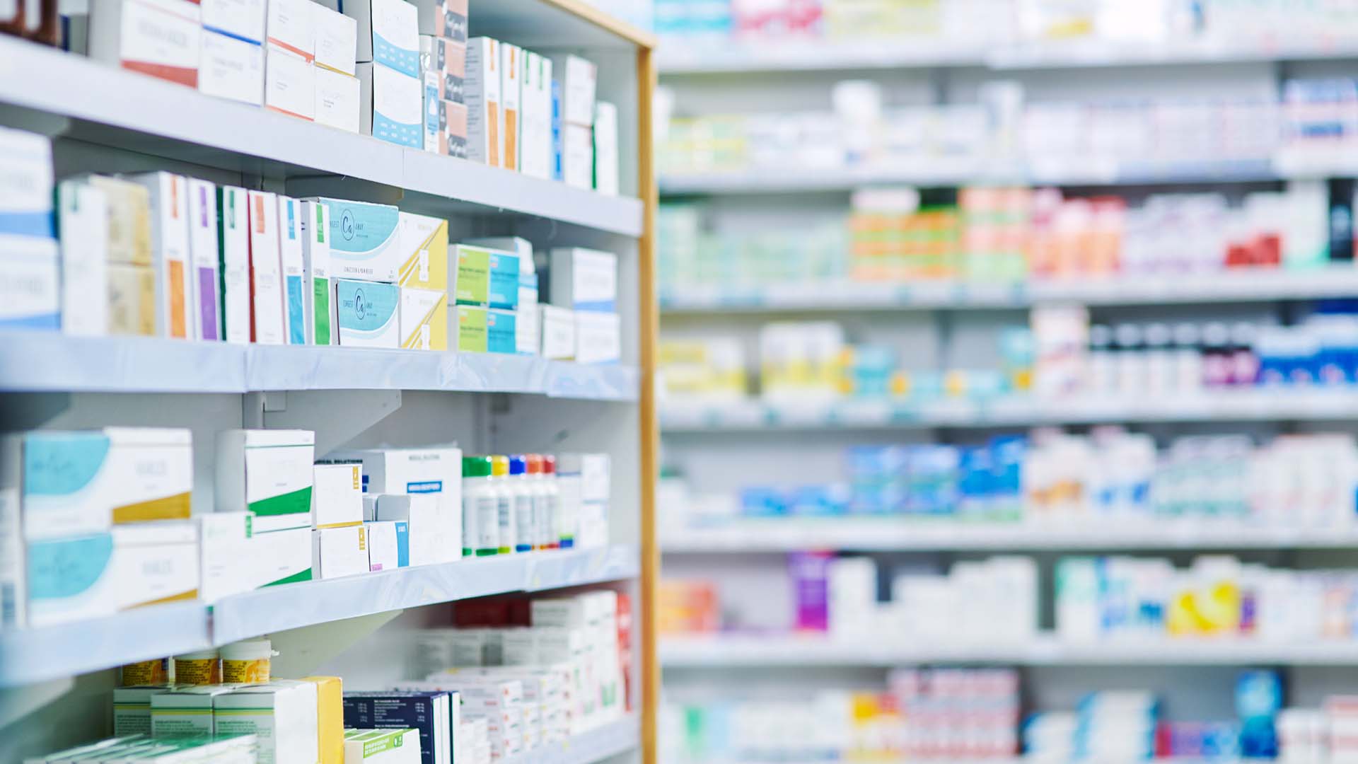 Image of pills next to a medicine bottle